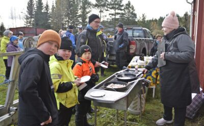 –Kala on kyllä hyvää. Suosikki on ahven, toteavat Iisakki Pellinen (vas.), Leo ja Aleksi Lindholmin kuin yhdestä suusta. –Käytän paistamiseen sitruunaöljyä, joskus chili- tai valkosipuliöljyä, kertoo Asta Asunmaa (oik.) Maistiaisia odottamassa Lauri Pellinen.